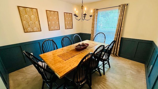 dining space with a notable chandelier and light colored carpet