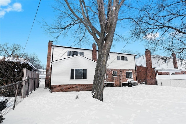 view of snow covered back of property