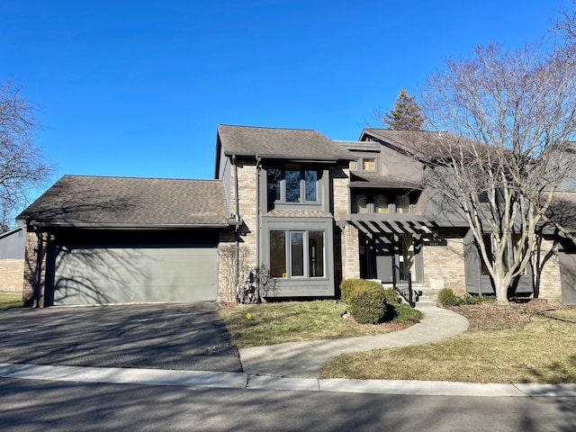 view of front of home featuring a garage, a shingled roof, aphalt driveway, and brick siding