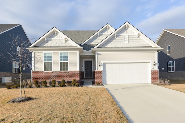 craftsman-style home featuring a garage and a front lawn