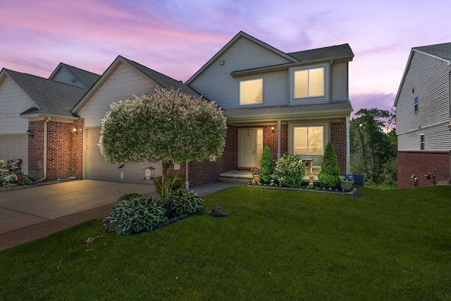 view of front facade with a garage, a lawn, and central AC unit