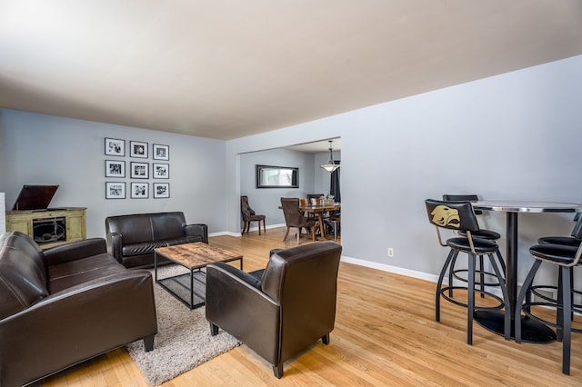 living area featuring light wood-type flooring and baseboards