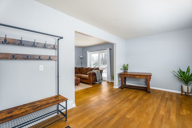 interior space featuring light wood-style flooring and baseboards