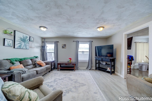 living room with hardwood / wood-style flooring and a textured ceiling