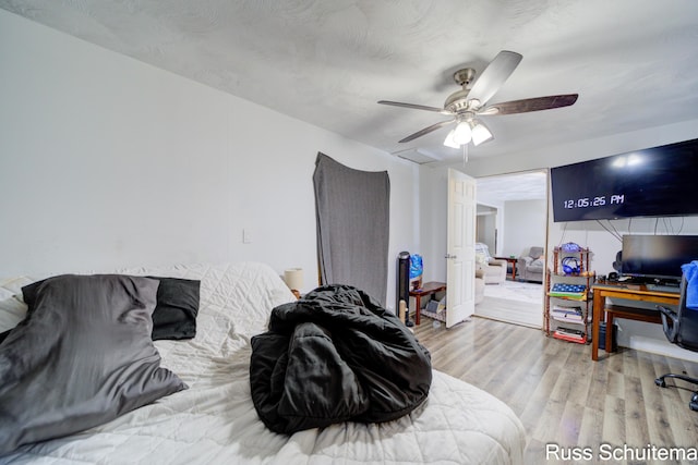 bedroom with ceiling fan and light hardwood / wood-style flooring