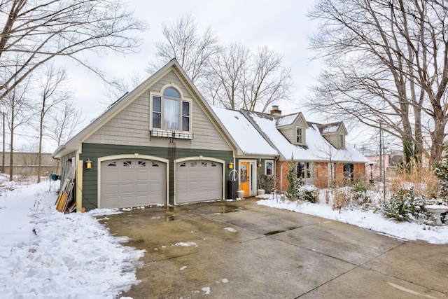 view of front of home featuring a garage, driveway, and a chimney