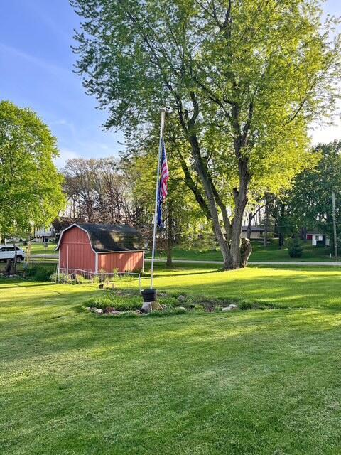 view of community with a yard and an outdoor structure