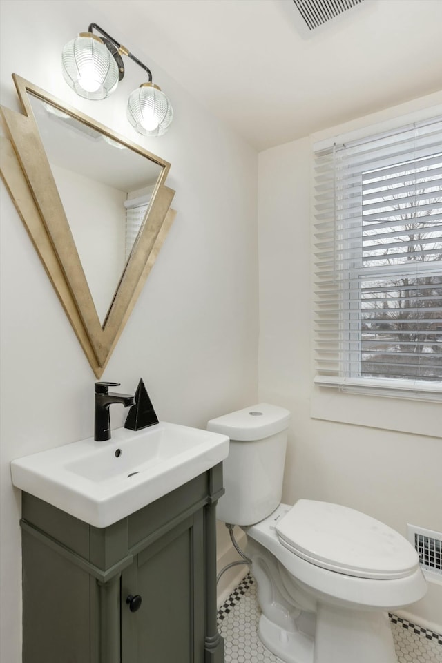 bathroom featuring toilet and vanity