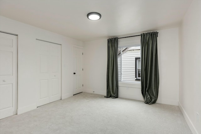 unfurnished bedroom with light carpet