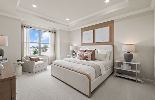 bedroom featuring a tray ceiling, carpet flooring, and ornamental molding