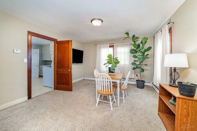 carpeted dining area with washer / clothes dryer and a baseboard radiator