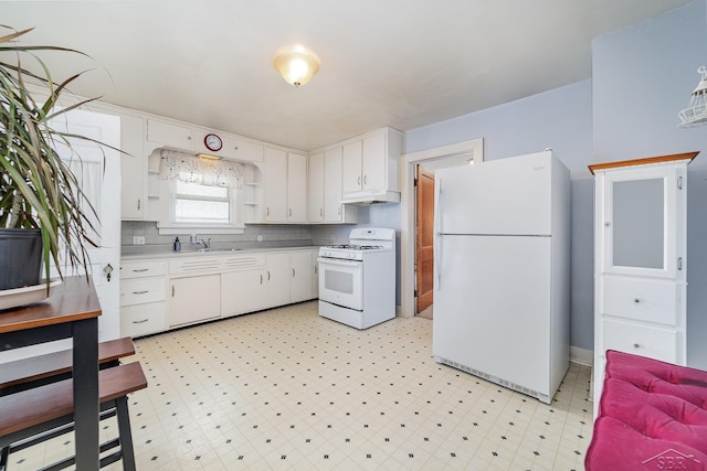 kitchen with white cabinetry, white appliances, sink, and decorative backsplash