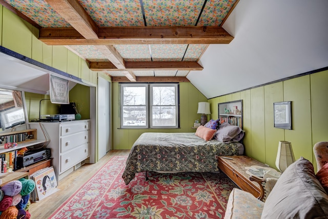 bedroom featuring vaulted ceiling with beams and light wood-style flooring