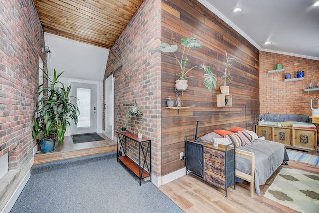 interior space featuring brick wall, ornamental molding, high vaulted ceiling, and wood finished floors