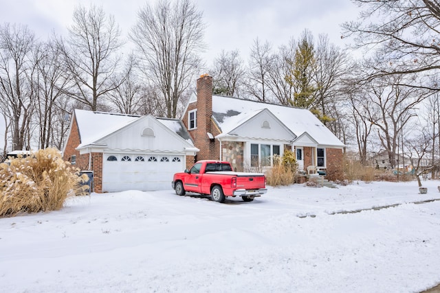 view of front of property with brick siding, a chimney, and an attached garage