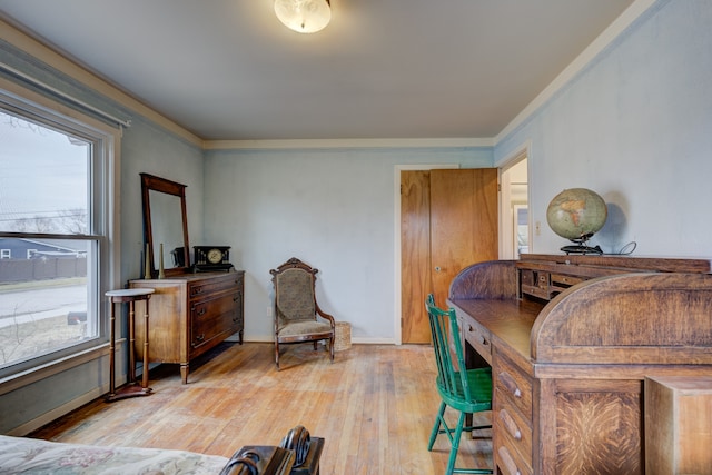 home office with wood-type flooring, crown molding, and baseboards