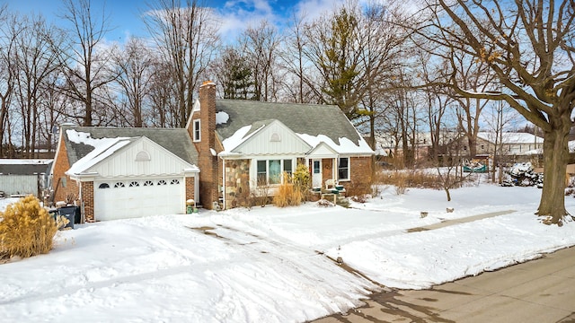 view of front of home featuring board and batten siding, brick siding, a chimney, and an attached garage