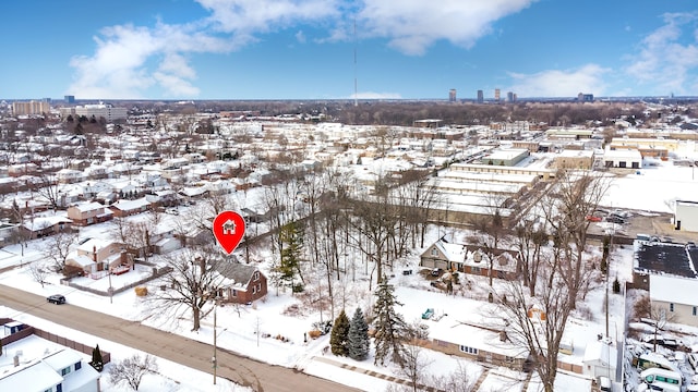 snowy aerial view with a city view