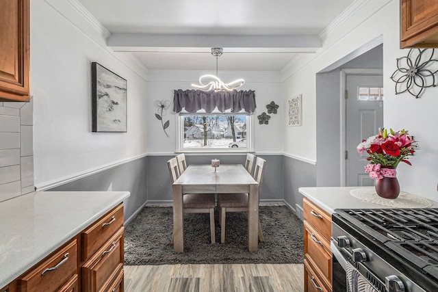 dining room with plenty of natural light, beamed ceiling, and hardwood / wood-style floors