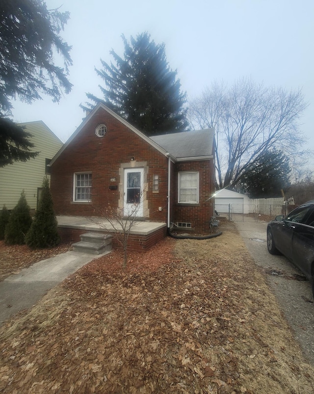 view of front of house with a garage and an outdoor structure