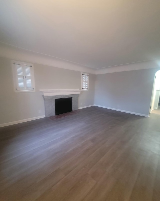 unfurnished living room with dark hardwood / wood-style floors