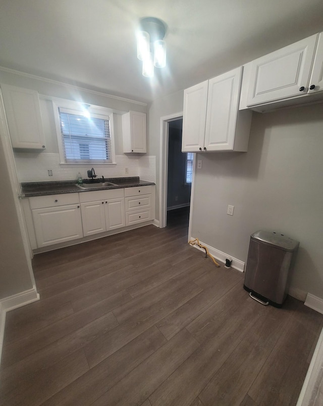 kitchen featuring white cabinetry and sink