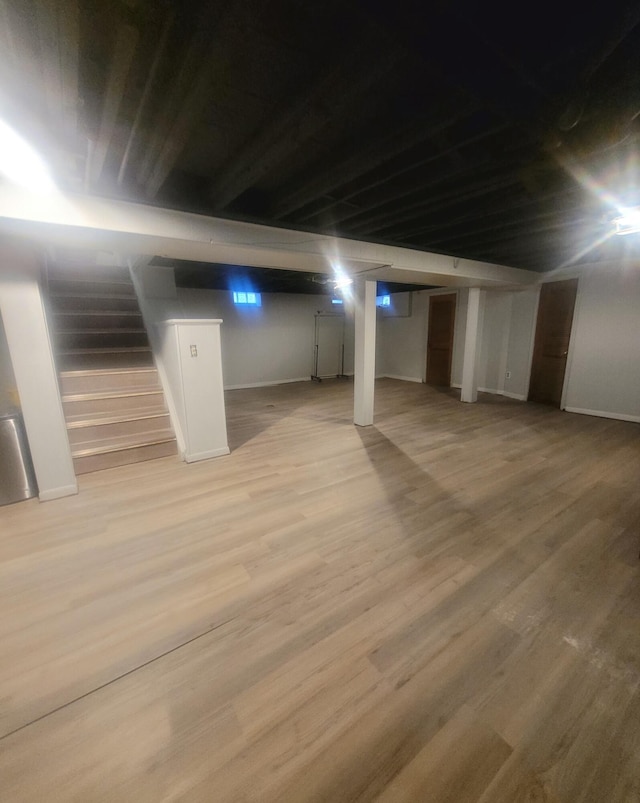 basement with light hardwood / wood-style floors