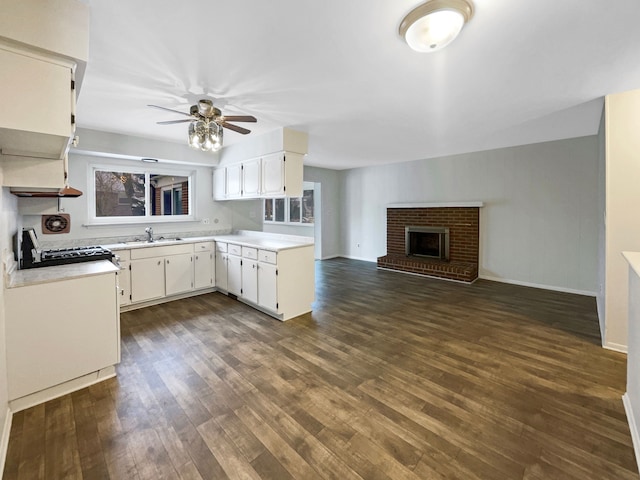 29743 Chelmsford Rd, Southfield, MI 48076 - kitchen featuring white cabinetry, light countertops, dark wood-type flooring, and open floor plan