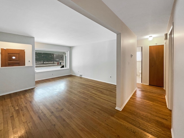 29743 Chelmsford Rd, Southfield, MI 48076 - empty room with dark wood-type flooring, visible vents, and baseboards