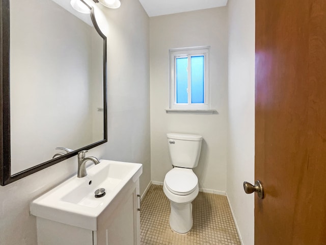 29743 Chelmsford Rd, Southfield, MI 48076 - half bathroom featuring toilet, vanity, baseboards, and tile patterned floors