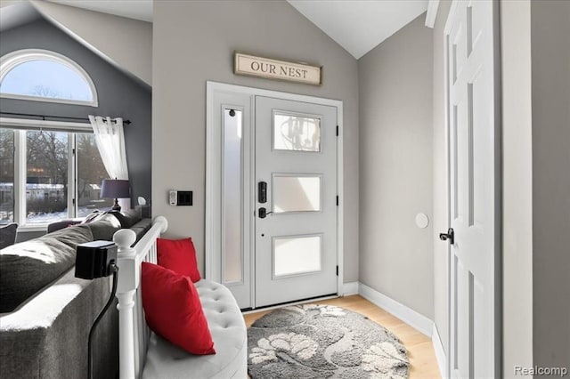 entryway with vaulted ceiling and hardwood / wood-style floors