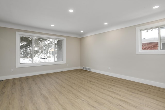 unfurnished room with light wood-type flooring