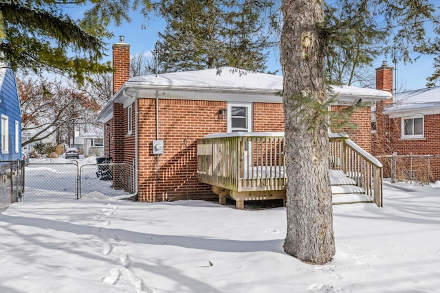 snow covered property with a deck