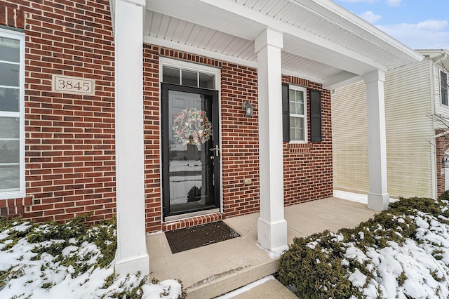 view of snow covered property entrance