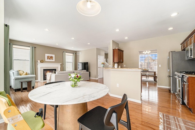 dining area featuring light wood-type flooring