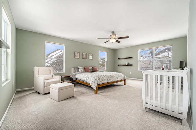 carpeted bedroom featuring ceiling fan and multiple windows