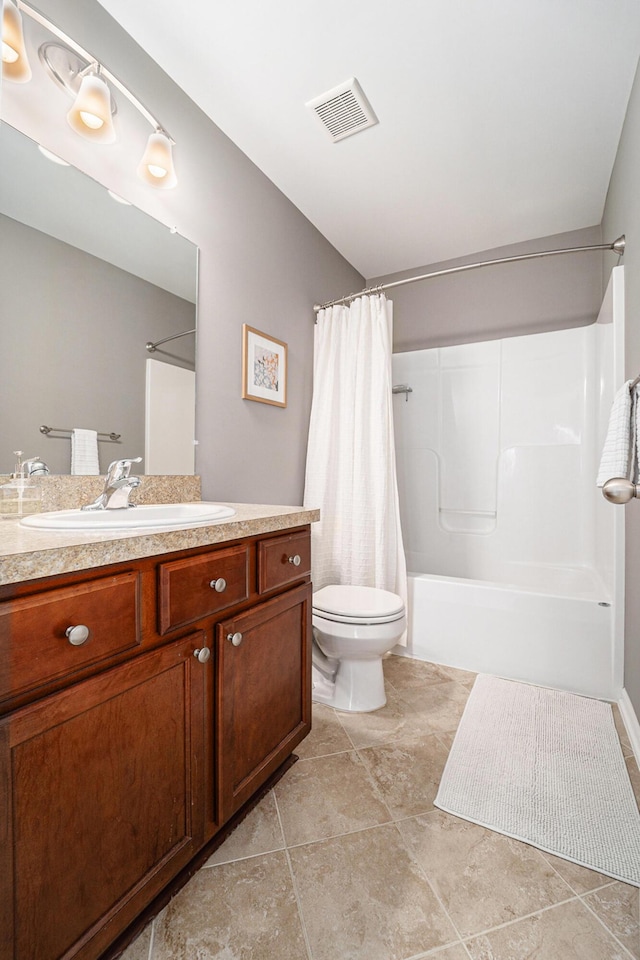 full bathroom featuring vanity, tile patterned flooring, toilet, and shower / bath combo