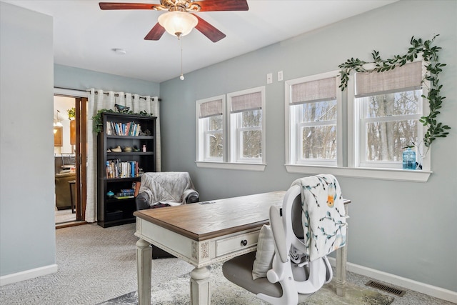 carpeted office featuring ceiling fan