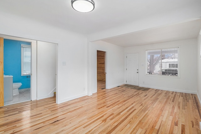 interior space featuring baseboards and light wood-style floors