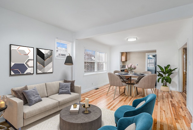 living room featuring light wood-style flooring and baseboards