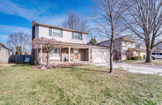 front of property featuring covered porch, a front yard, and a garage