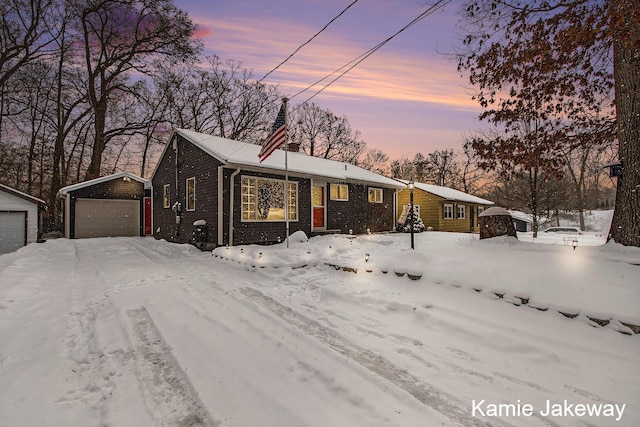 ranch-style house with a garage and an outbuilding