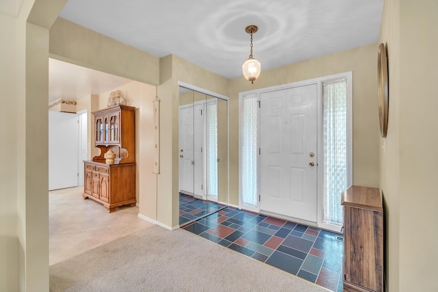 view of carpeted foyer entrance