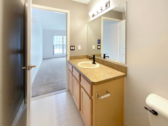 bathroom featuring toilet, tile patterned floors, and vanity