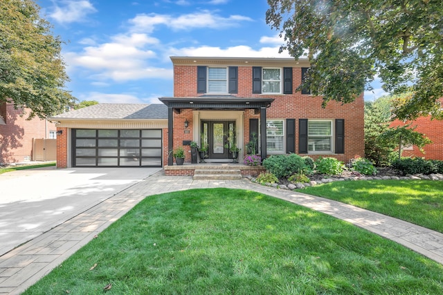 view of front of property featuring a front yard and a garage