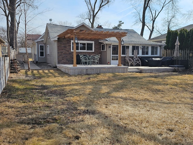 back of house featuring a patio area, a lawn, a pergola, and fence