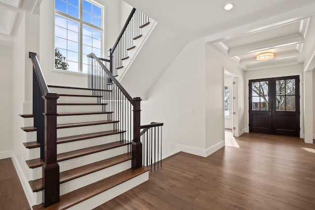 entrance foyer featuring french doors, crown molding, dark hardwood / wood-style floors, and beam ceiling