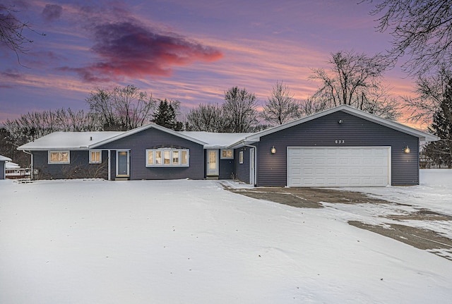 ranch-style home featuring a garage