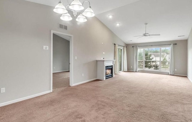 unfurnished living room featuring a warm lit fireplace, lofted ceiling, ceiling fan with notable chandelier, light carpet, and visible vents