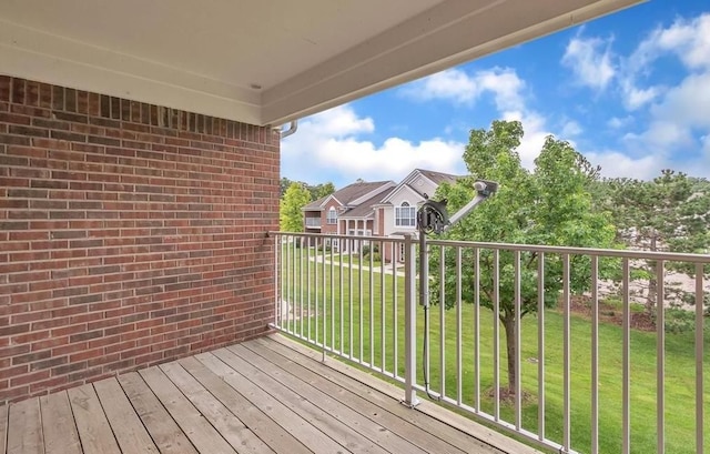 wooden terrace featuring a lawn